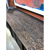 Close view of textured sideboard top surface.