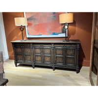Sideboard with lamps and artwork, interior setting.