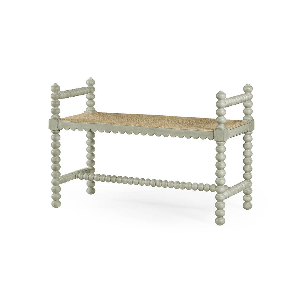 Grey painted Jacobean bench with spindle details, angled view.