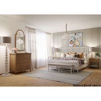 Spacious bedroom with white king size spindle bed frame.