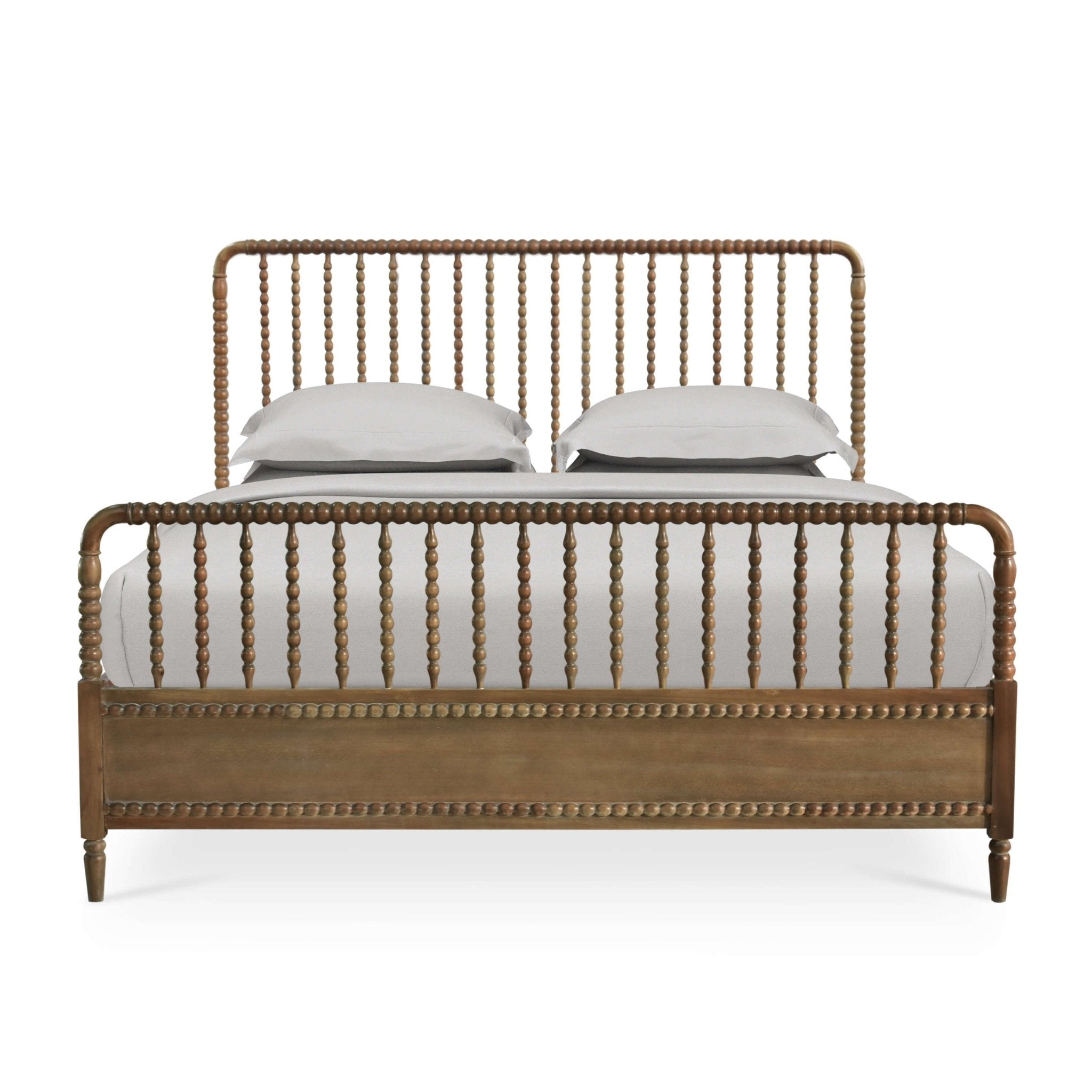 Front view of king size spindle bed frame with pillows.