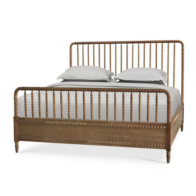 King size spindle bed frame with bedding, angled view.