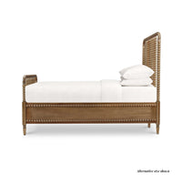 Side view of king size spindle bed frame with bedding.