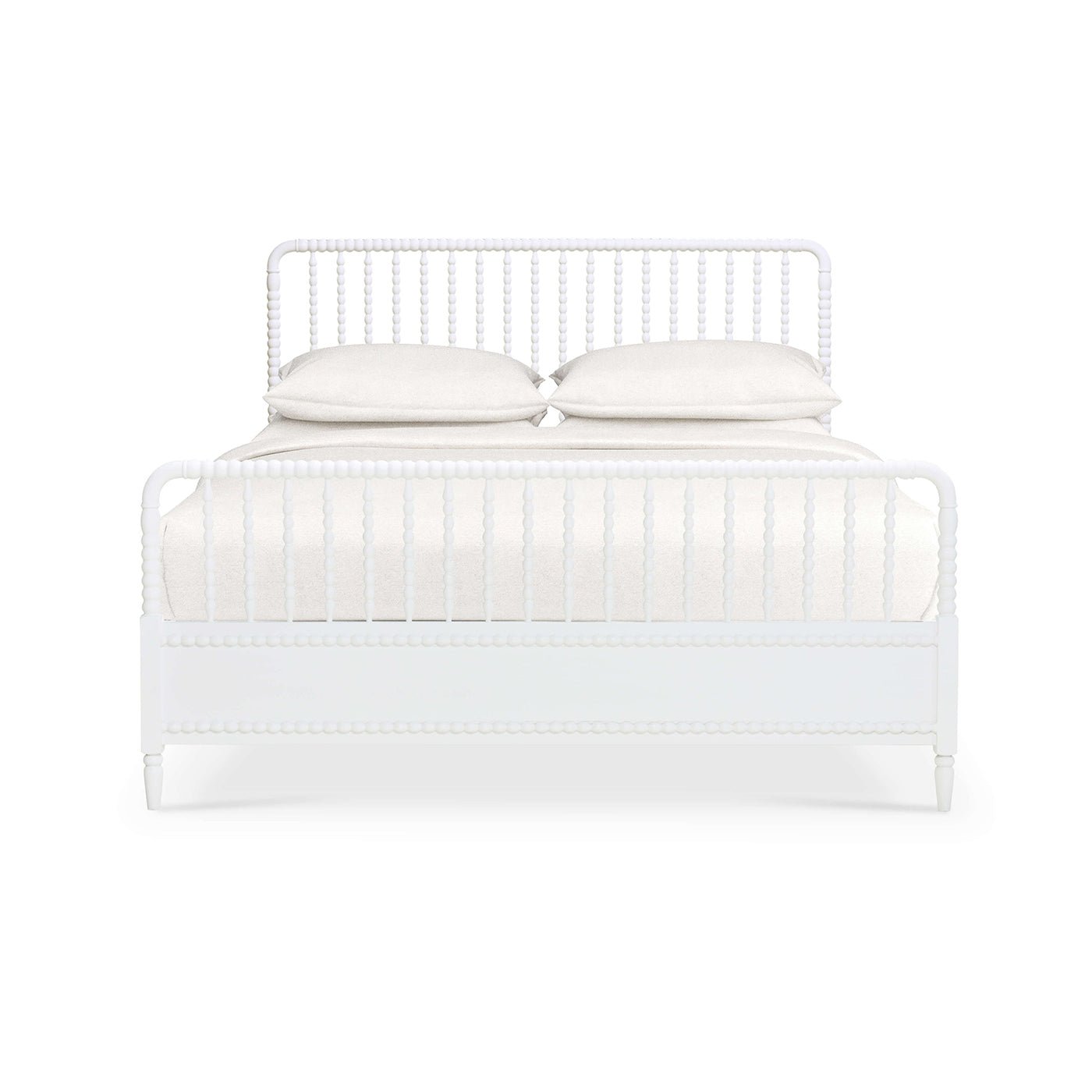 Front view of white spindle bed frame with pillows.