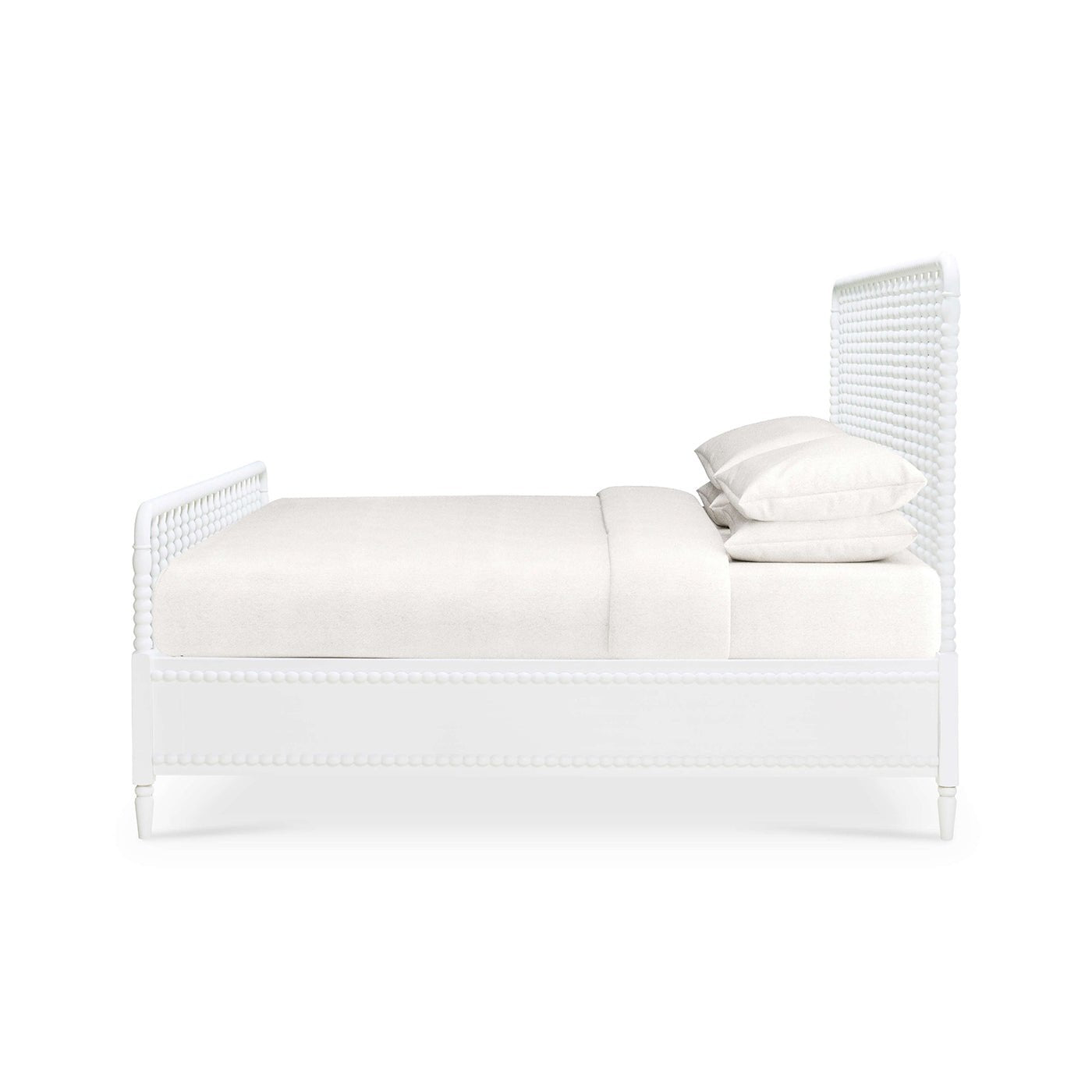 Side view of white spindle bed frame, no bedding.