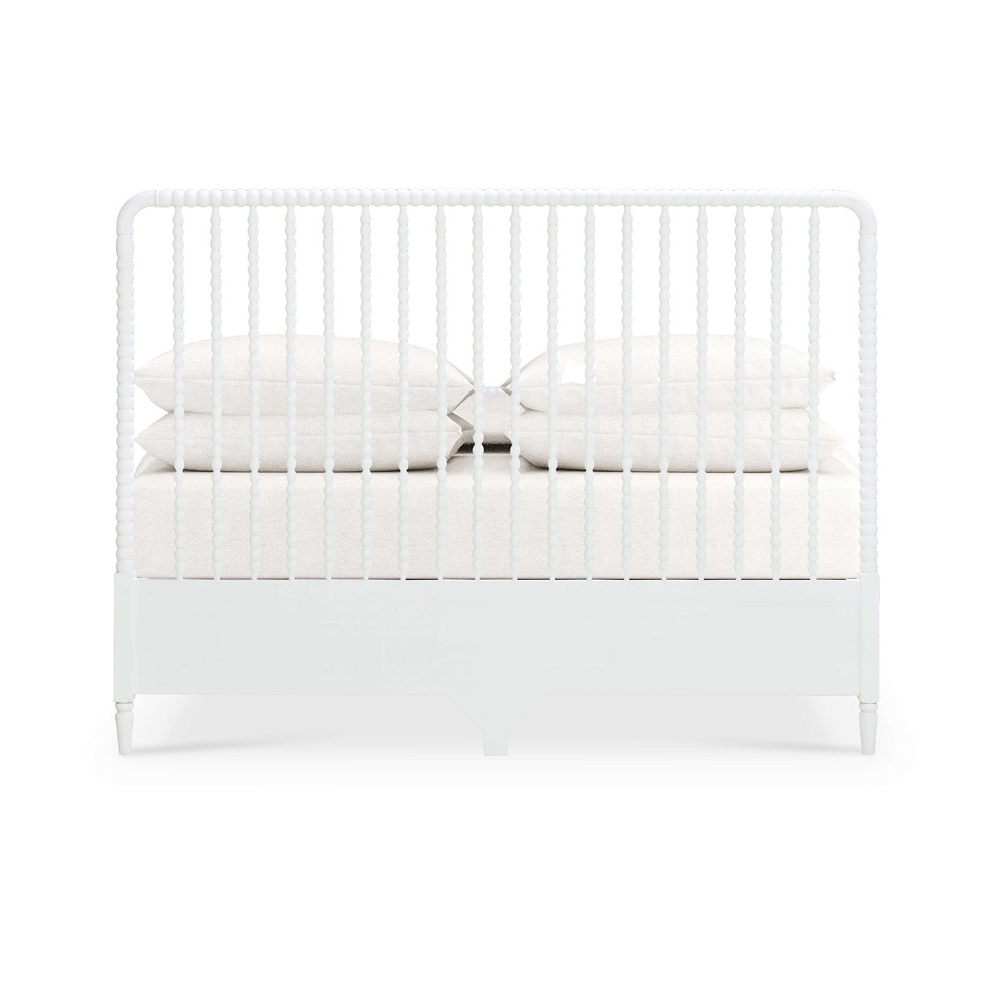 Back view of white spindle bed with pillows.