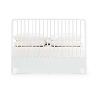 Back view of white spindle bed with pillows.