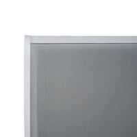 Close-up of headboard on upholstered linen king bed.