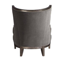 Back of gray Klismos wingchair, sleek upholstery detail.
