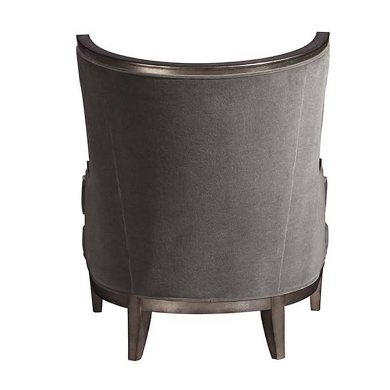 Back of gray Klismos wingchair, sleek upholstery detail.