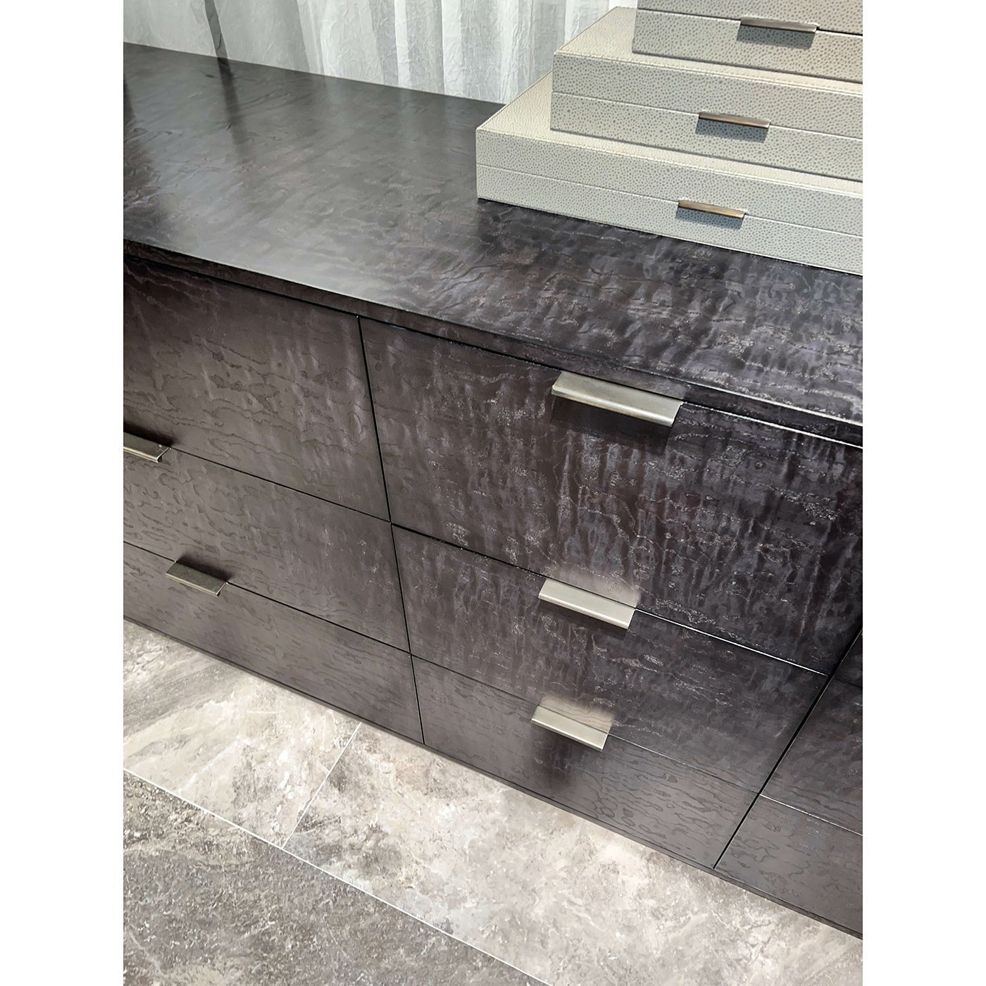Close-up of black dresser drawers and handles.