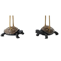 Turtles supporting crane statues, detailed close-up.