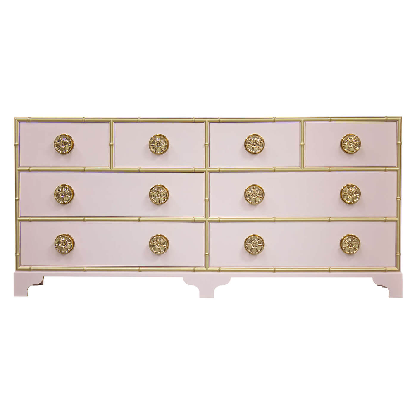 Pink dresser with gold accents and decorative knobs.