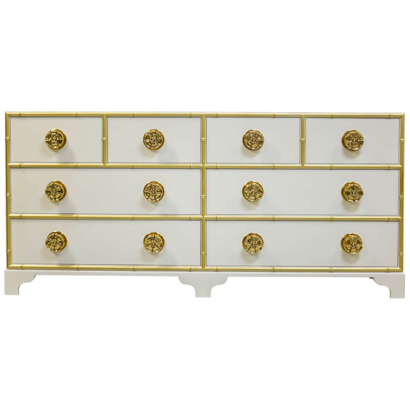 White dresser featuring gold accents and ornate knobs.