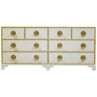 White dresser featuring gold accents and ornate knobs.