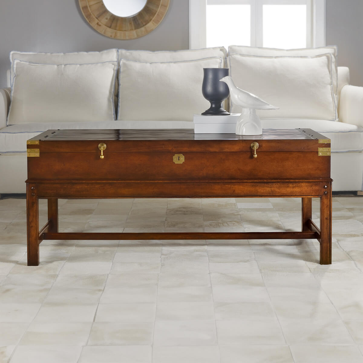 Wooden coffee table styled in front of a sofa.
