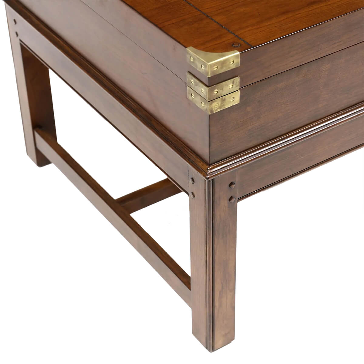 Close-up of wooden coffee table corner with brass hardware.