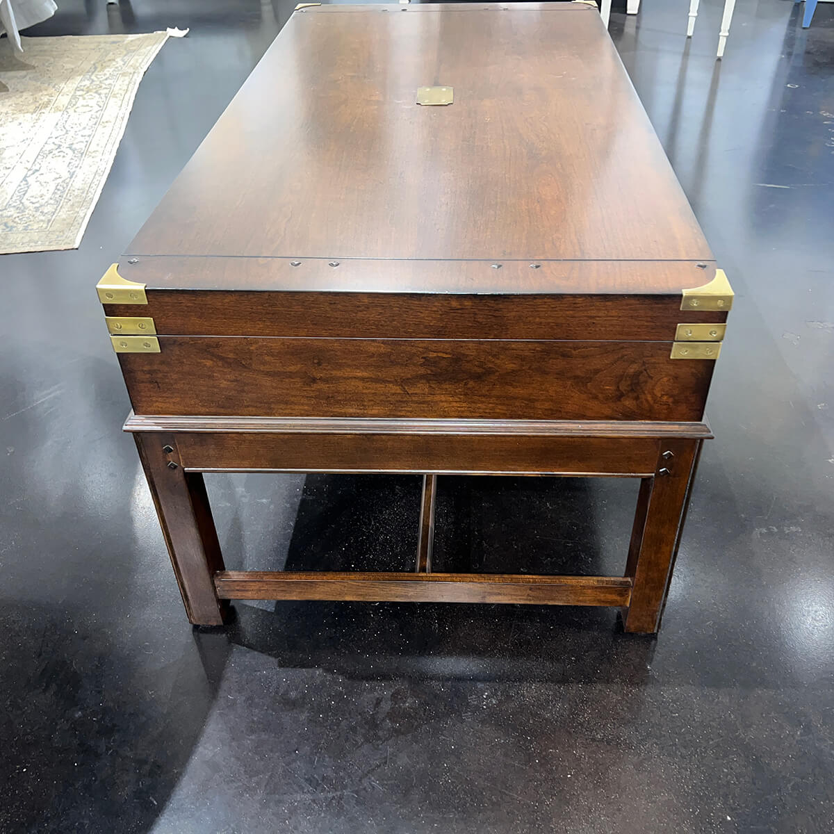 Rear view of wooden coffee table on a dark floor.