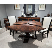 Dining table with extensions open, chairs around.