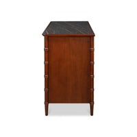 Side view of faux bamboo dresser with marble top.