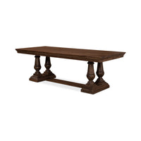 Dark wood dining table angled view, carved detailing.