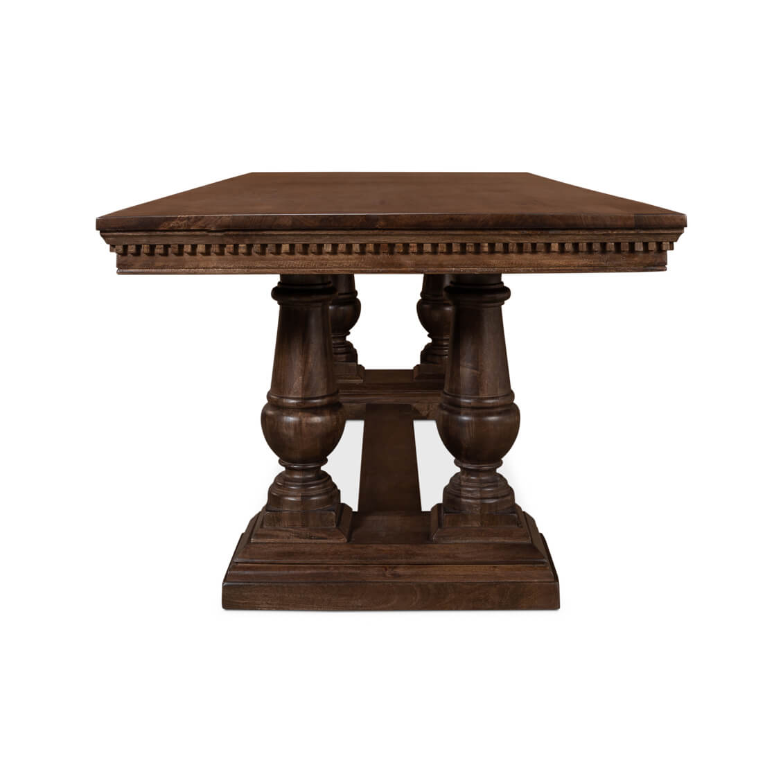 End view of dining table, carved symmetrical legs.