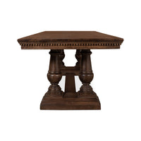End view of dining table, carved symmetrical legs.