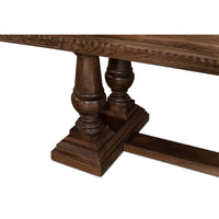 Close-up of dining table legs, carved pedestal base.