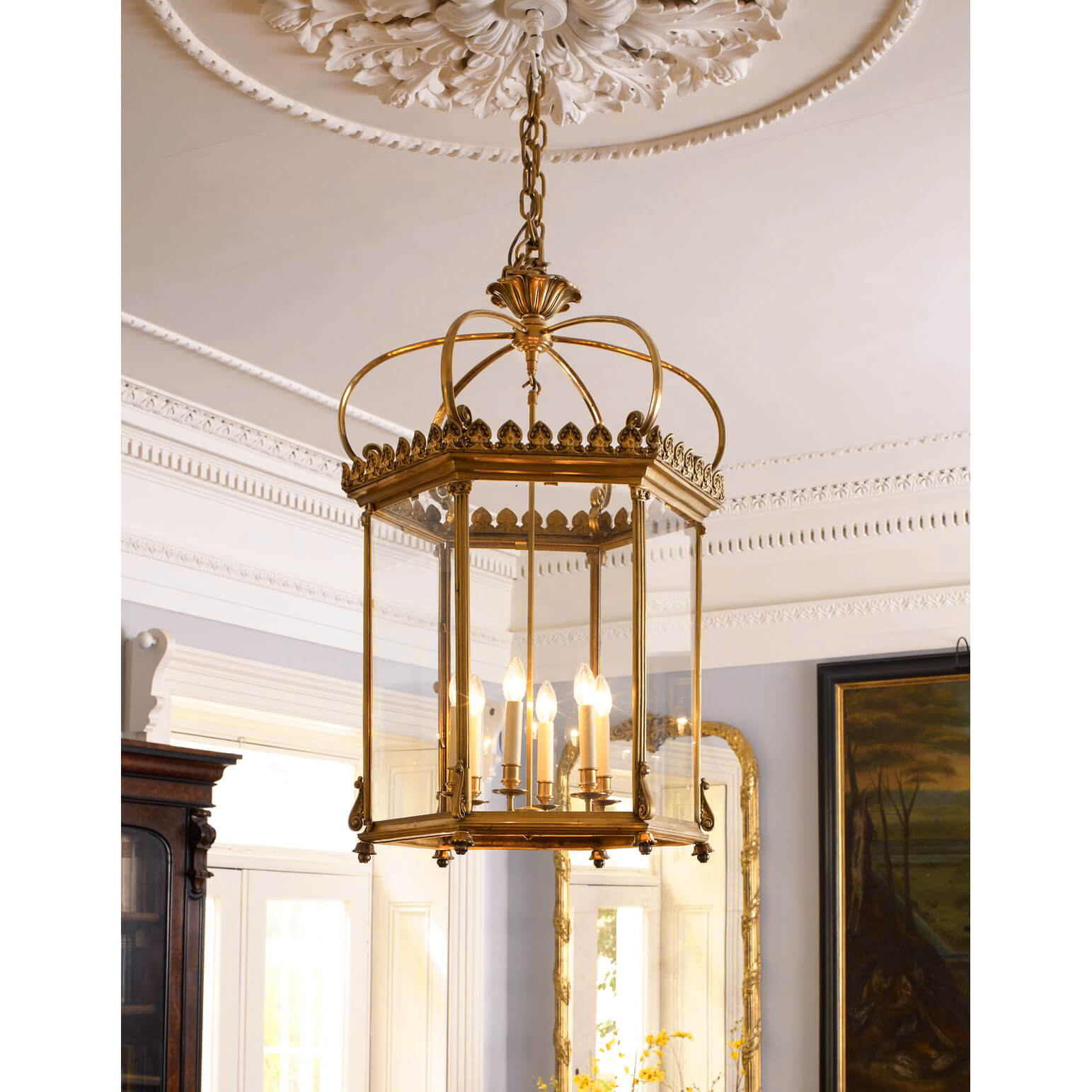 Georgian lantern illuminated in elegant dining room setting.