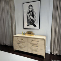 Dresser with decor and photograph, interior setting.