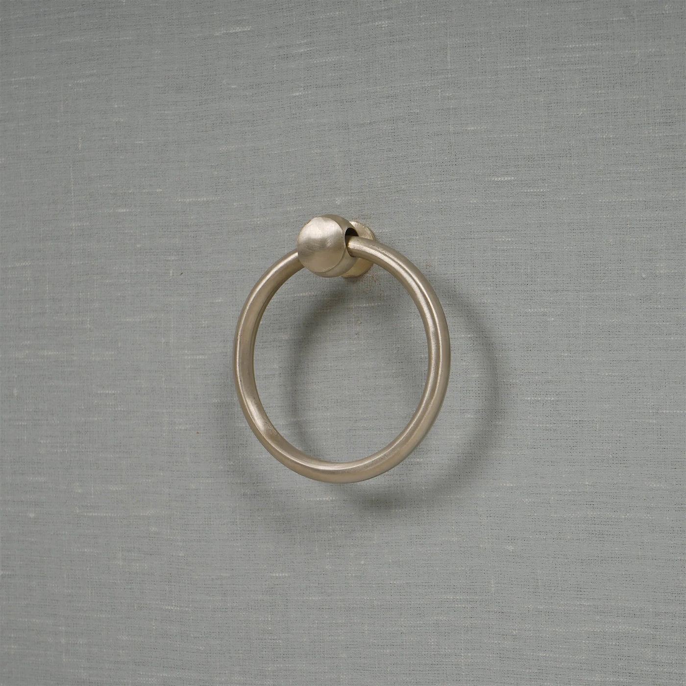 Decorative ring handle on pale blue etagere drawer.