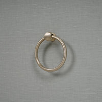 Decorative ring handle on pale blue etagere drawer.