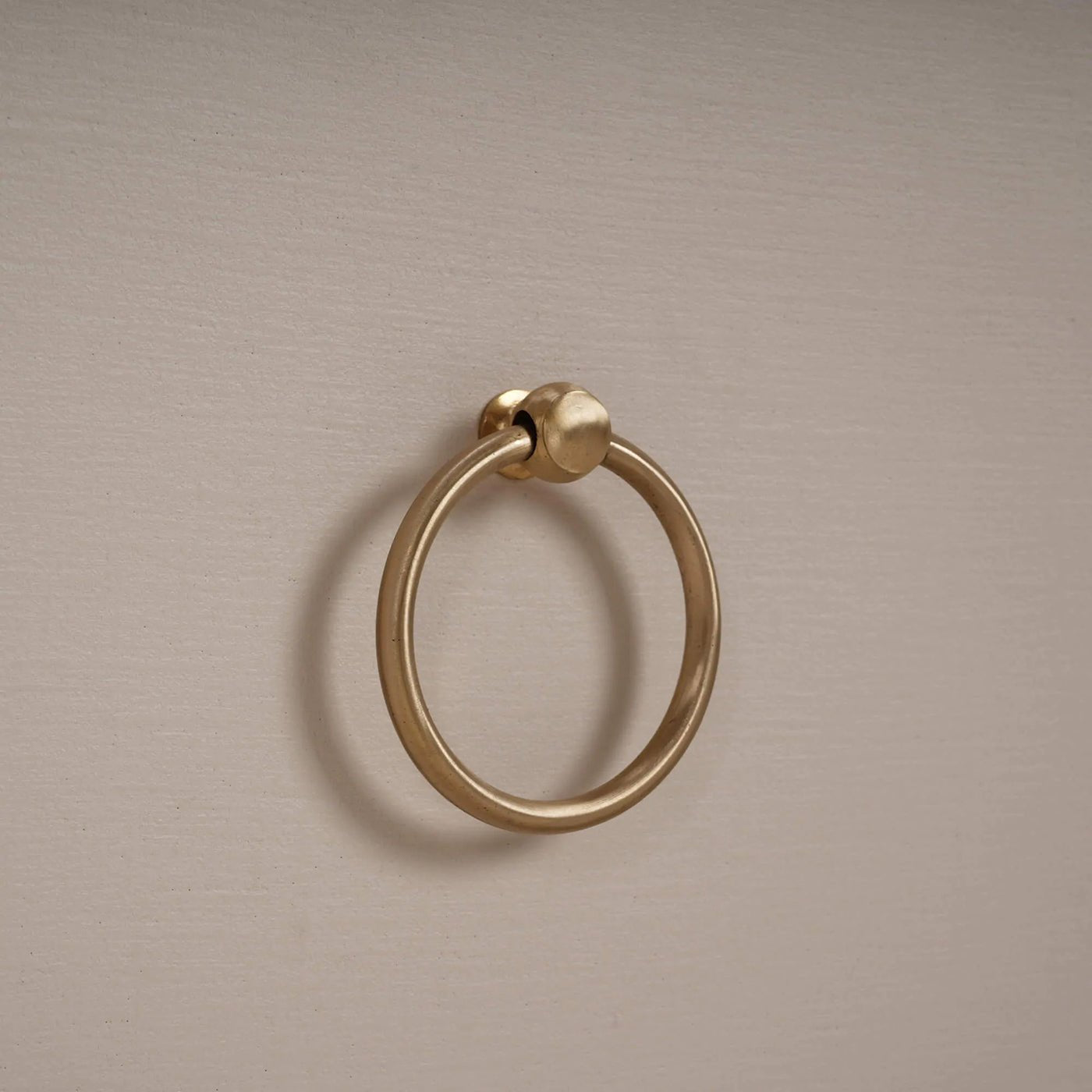 Close-up of gold ring drawer handle on etagere.