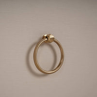 Close-up of gold ring drawer handle on etagere.
