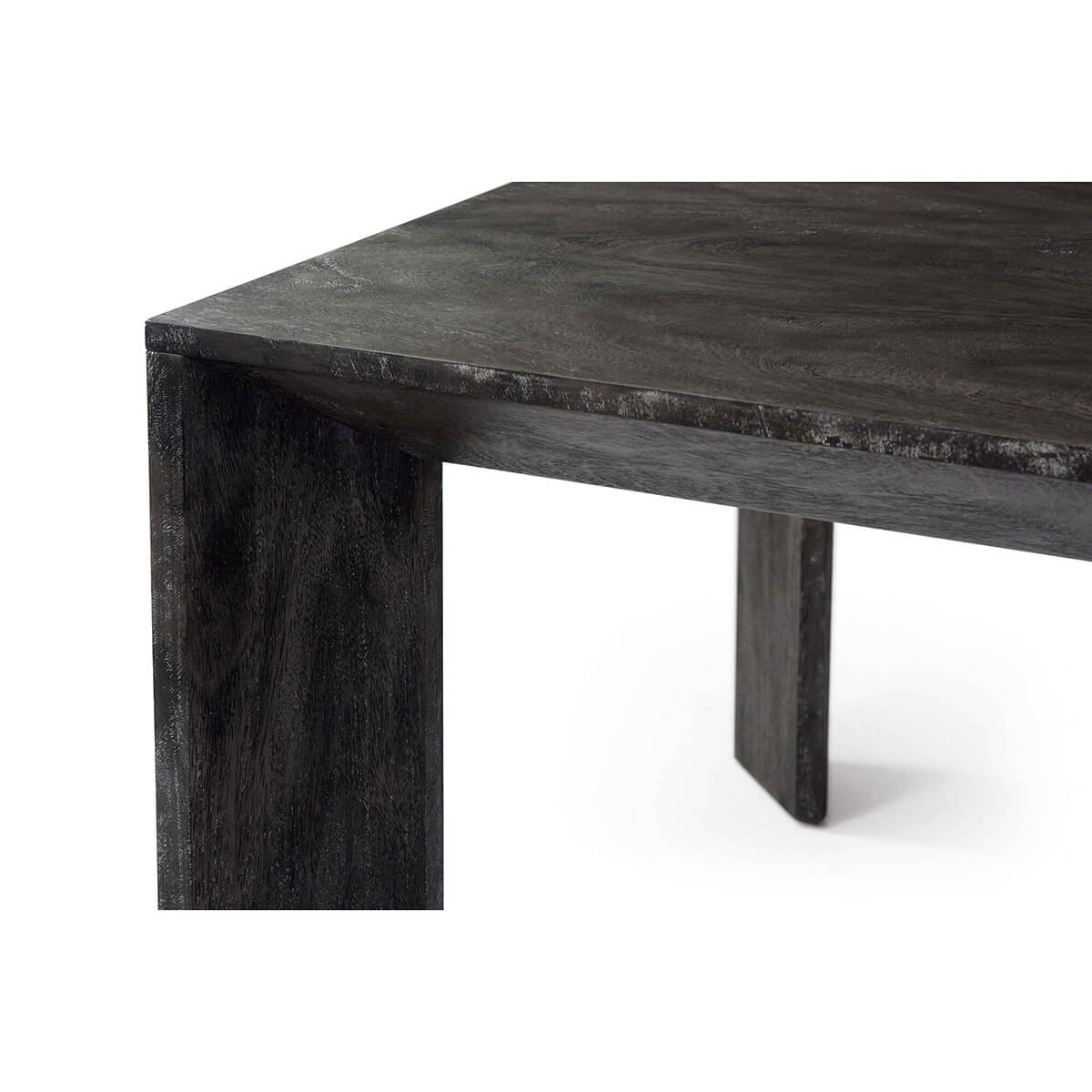 Close-up angled view of dining table corner and leg.