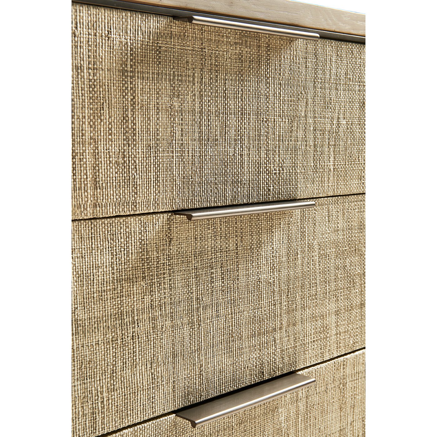 Close-up of three drawers with woven texture.