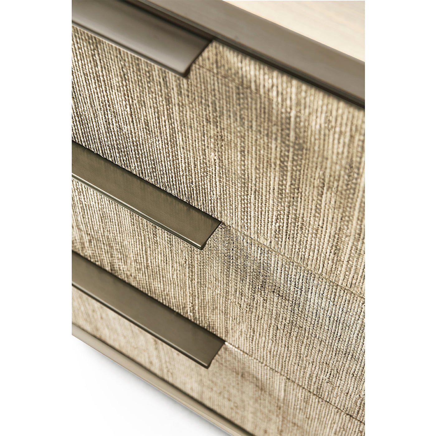 Close-up of drawer handles on woven nightstand.