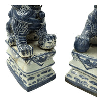 Base details of Chinese porcelain lions on pedestals.