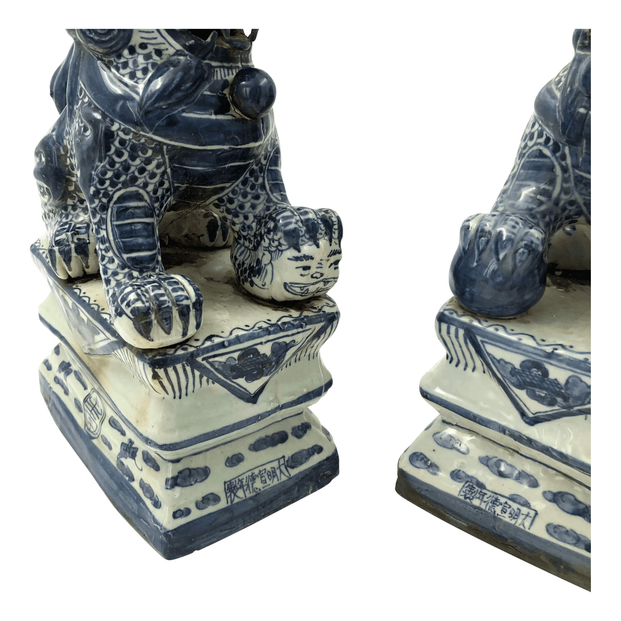 Base details of Chinese porcelain lions on pedestals.