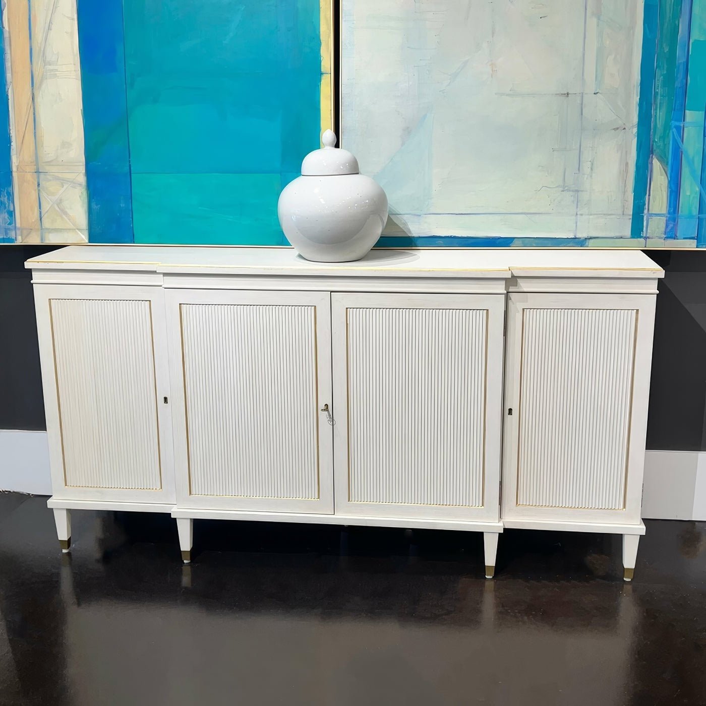 Regency credenza in gallery setting with decor item on top.
