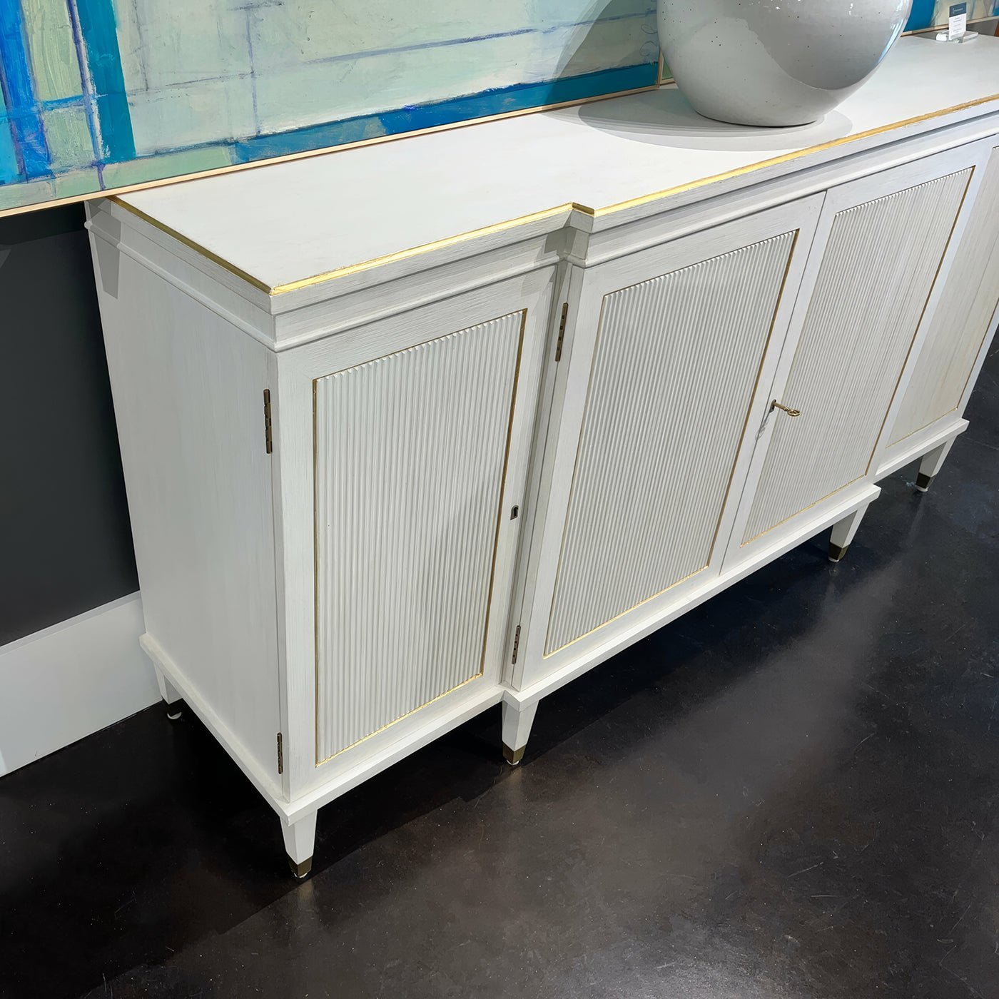 Top and side view of Regency credenza with blue artwork.