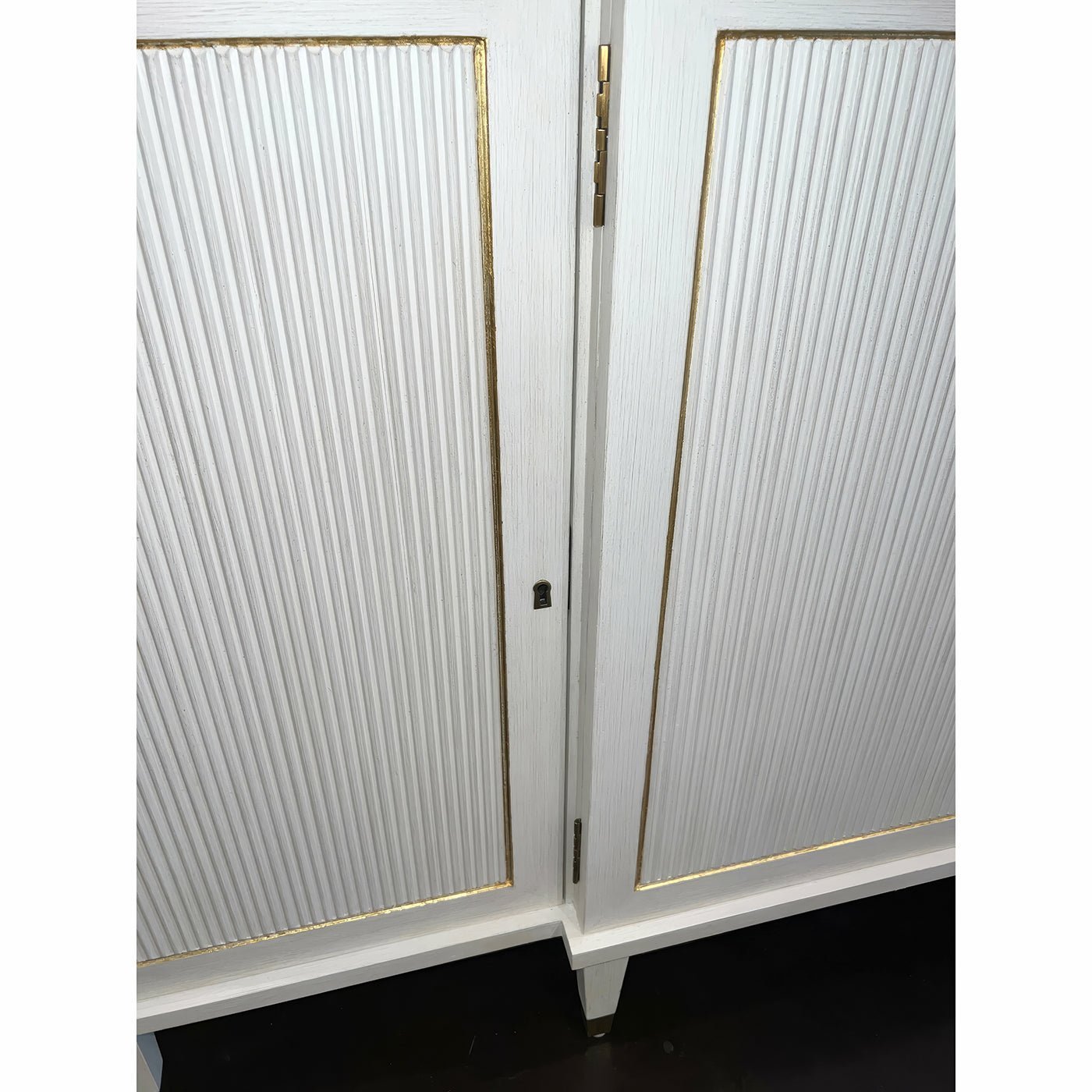 Close-up of Regency credenza door detail with gold trim.