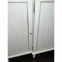Close-up of Regency credenza door detail with gold trim.
