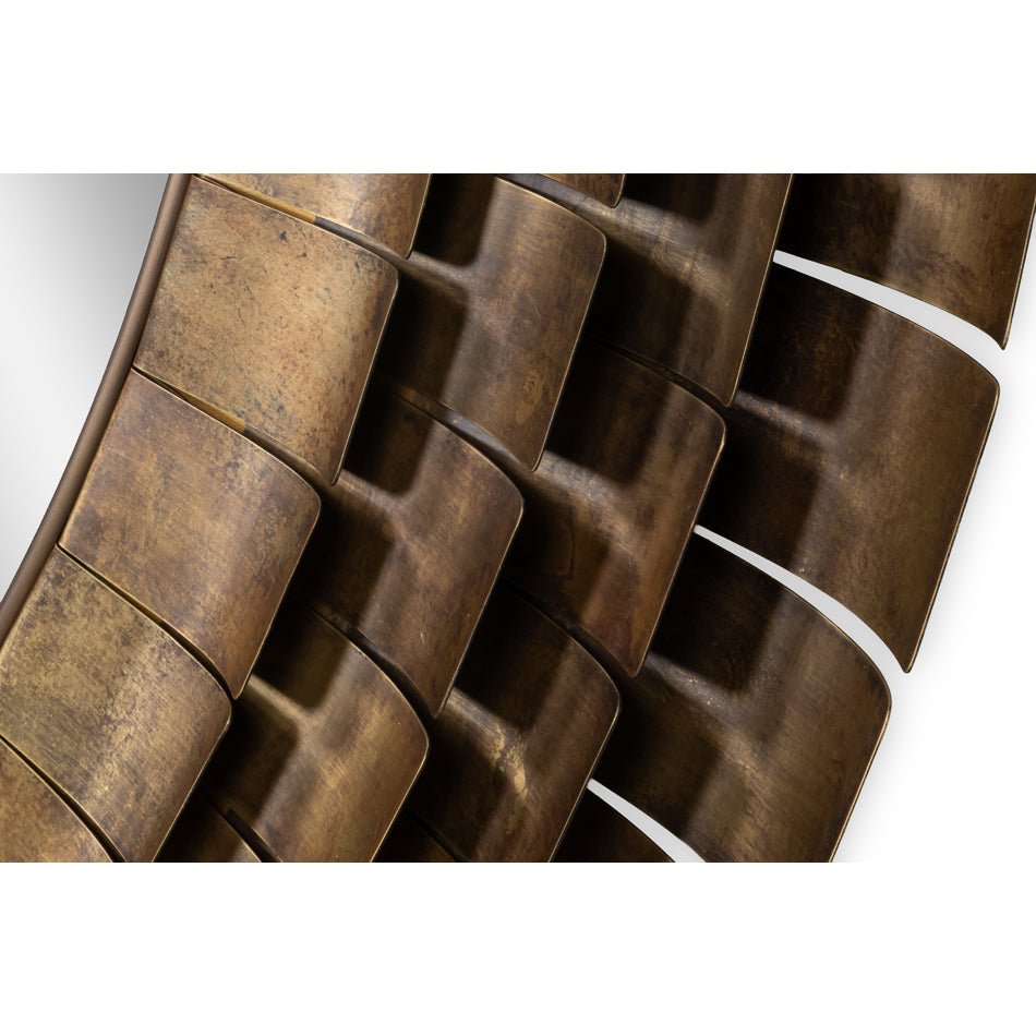 Detailed view of mirror's textured bronze frame.