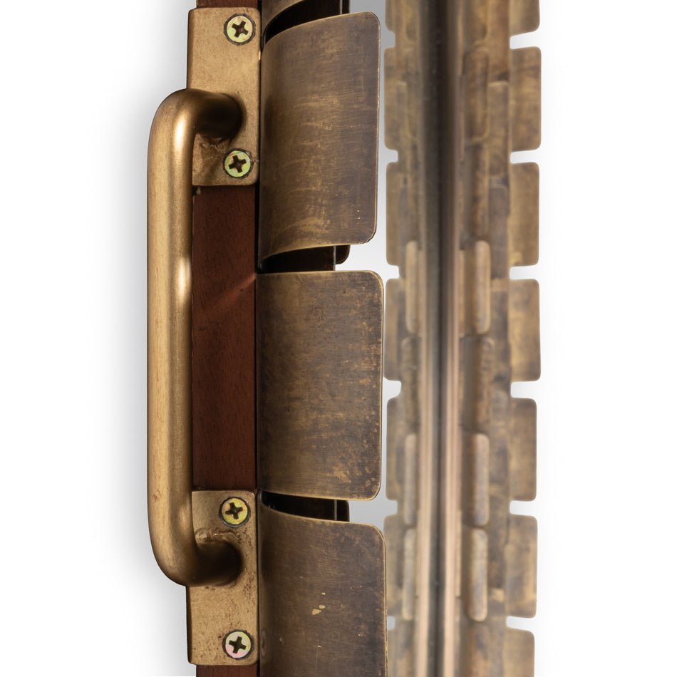 Mirror mounting hardware detail, bronze and wood features.