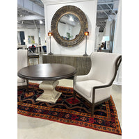Art Deco mirror in decor setup with table and chair.