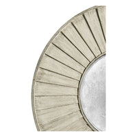Detailed view of textured frame on round mirror.