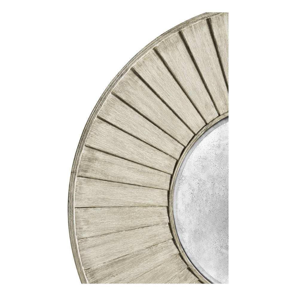 Detailed view of textured frame on round mirror.