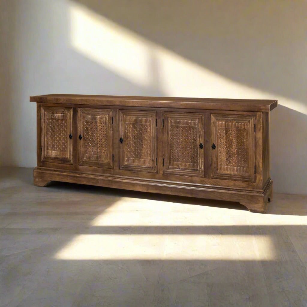 Rustic sideboard buffet in sunlit room setting.