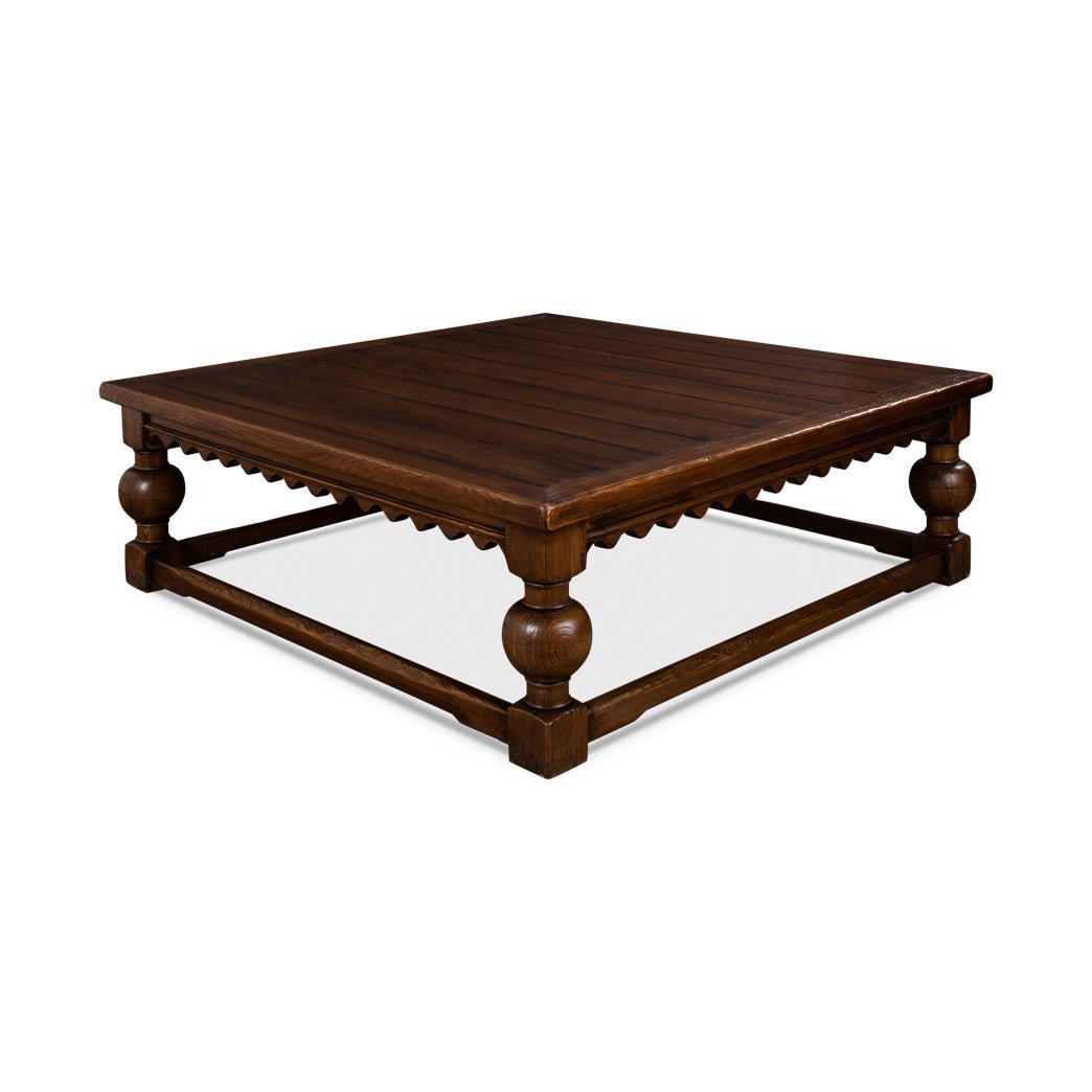 Side angle of rustic square coffee table, decorative legs visible.